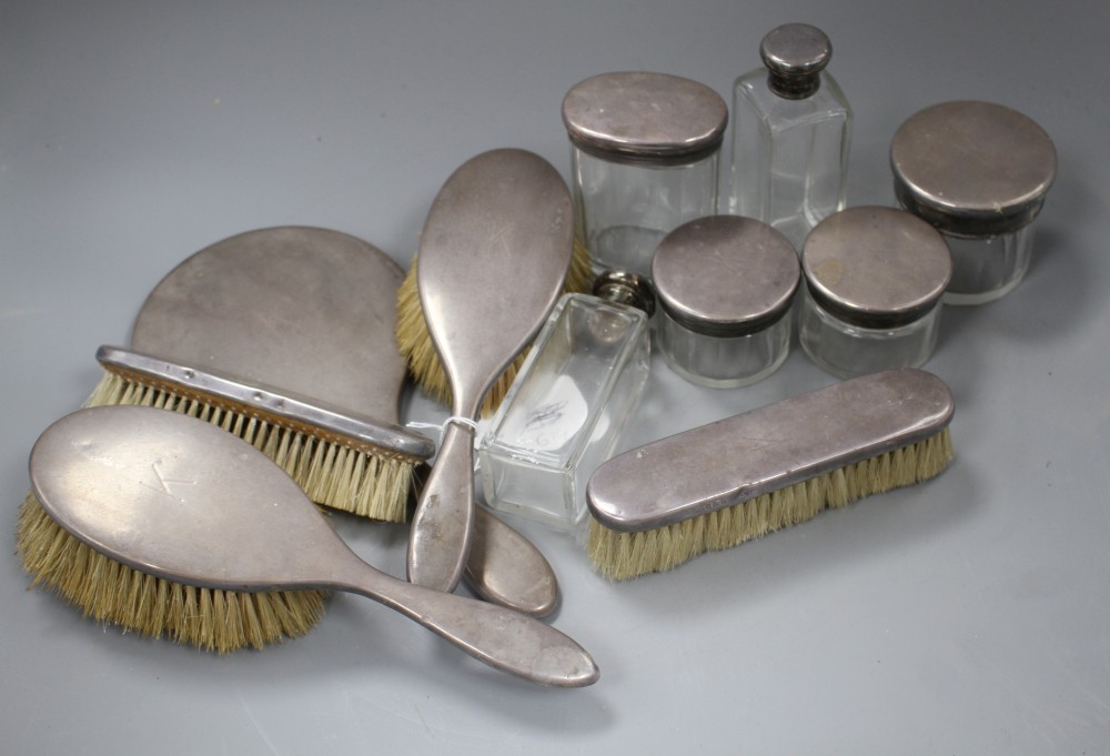 A George V eleven piece silver mounted dressing table set, by Asprey & Co, London, 1928, mirror 27.2cm.
